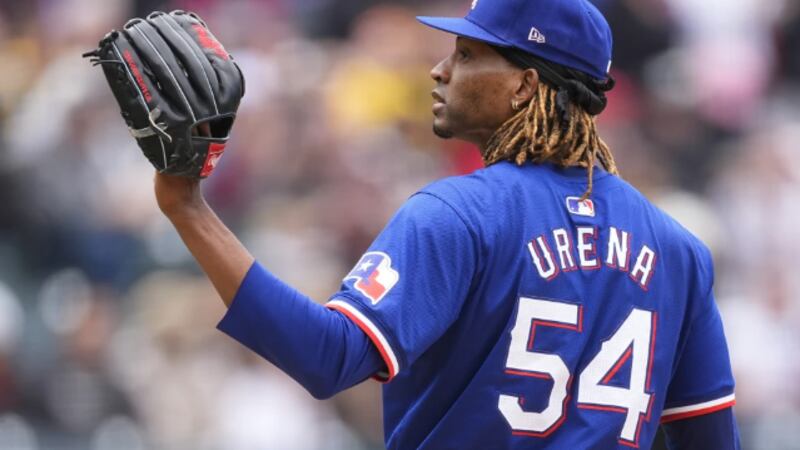 Texas Rangers pitcher José Ureña calls for a new ball after giving up a two-run home run to...