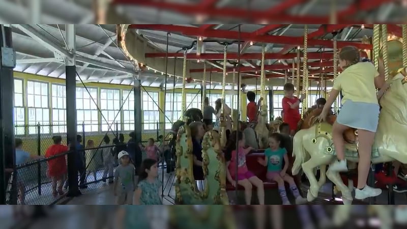 Horace Mann students excitedly board the Recreation Park carousel for the first ride of the...